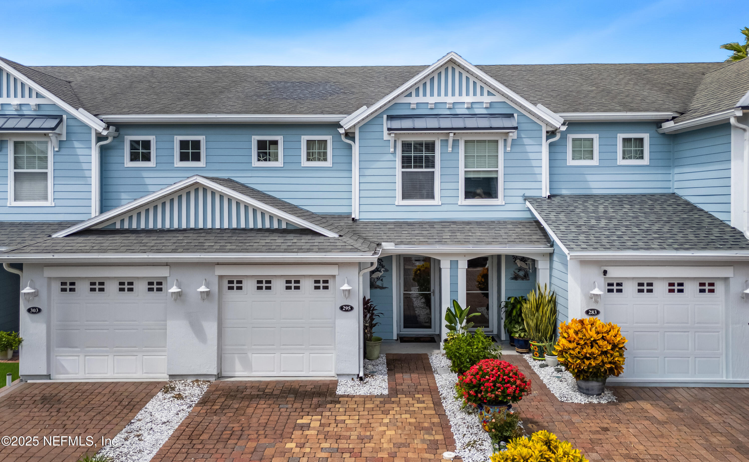 295 Islander Circle St. Augustine, FL 32080 - Photo 1 of 34 a front view of a house with garden
