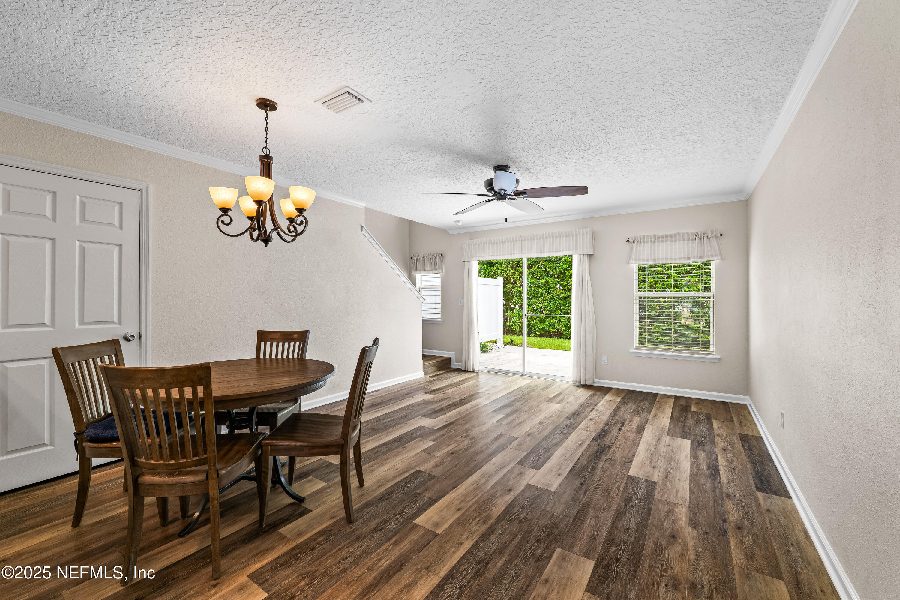 295 Islander Circle St. Augustine, FL 32080 - Photo 12 of 34 a view of a dining room with furniture a chandelier and wooden floor