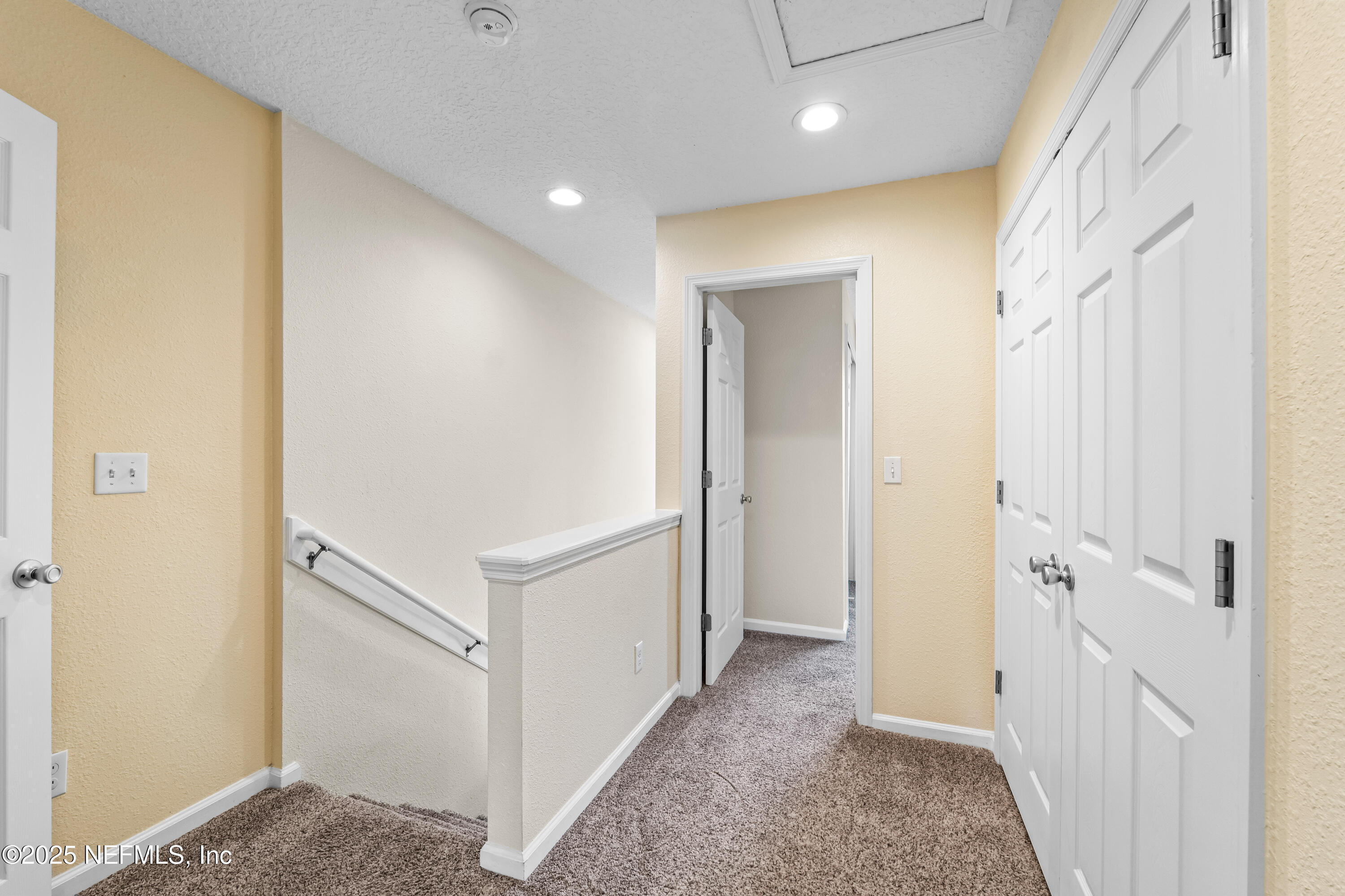 295 Islander Circle St. Augustine, FL 32080 - Photo 21 of 34 a view of a hallway with white walls