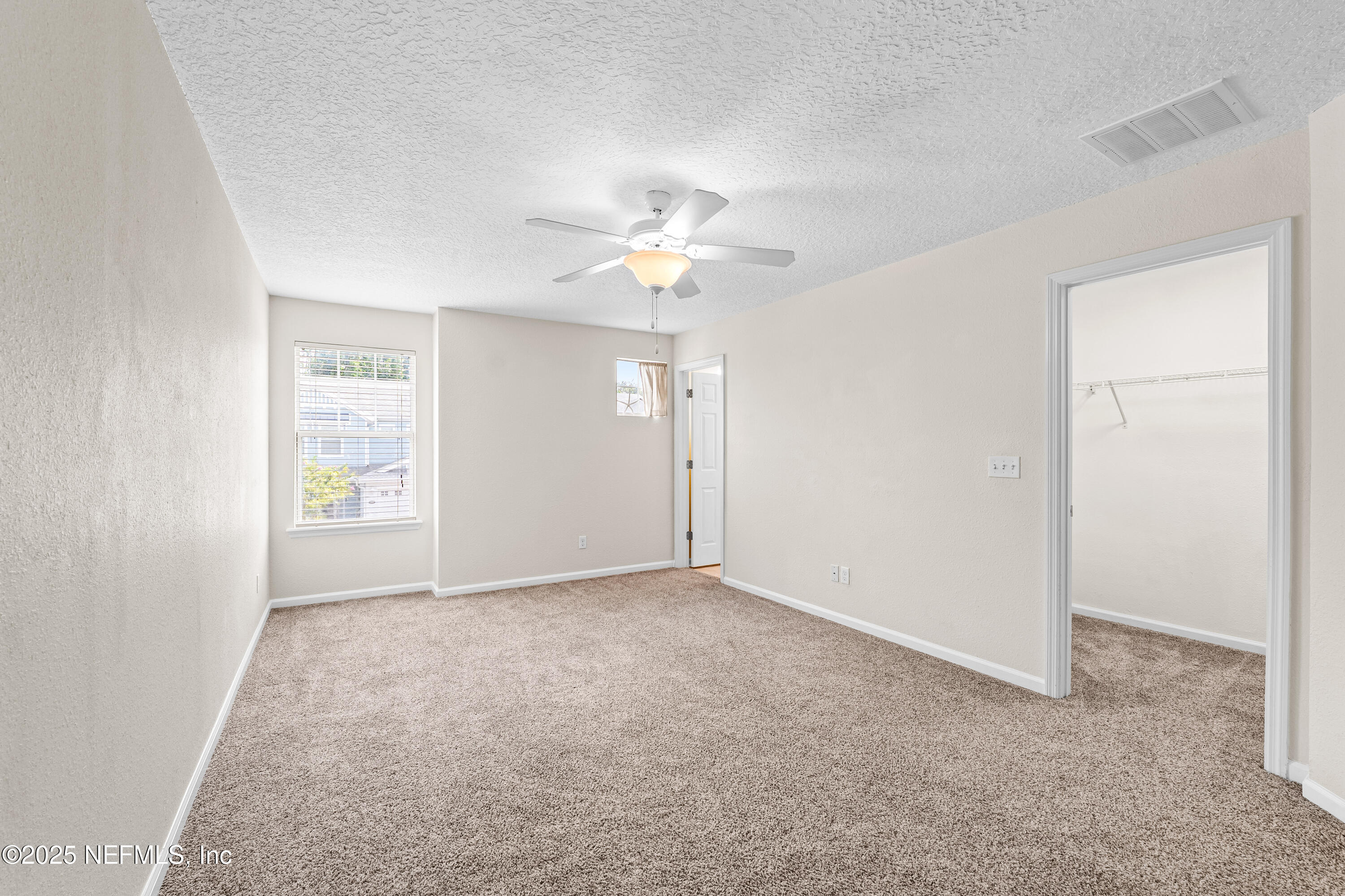 295 Islander Circle St. Augustine, FL 32080 - Photo 25 of 34 an empty room with a ceiling fan and a window