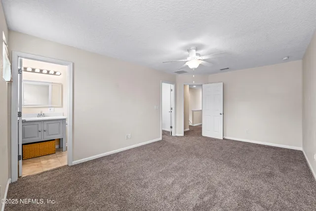 a bathroom with a toilet sink vanity and shower