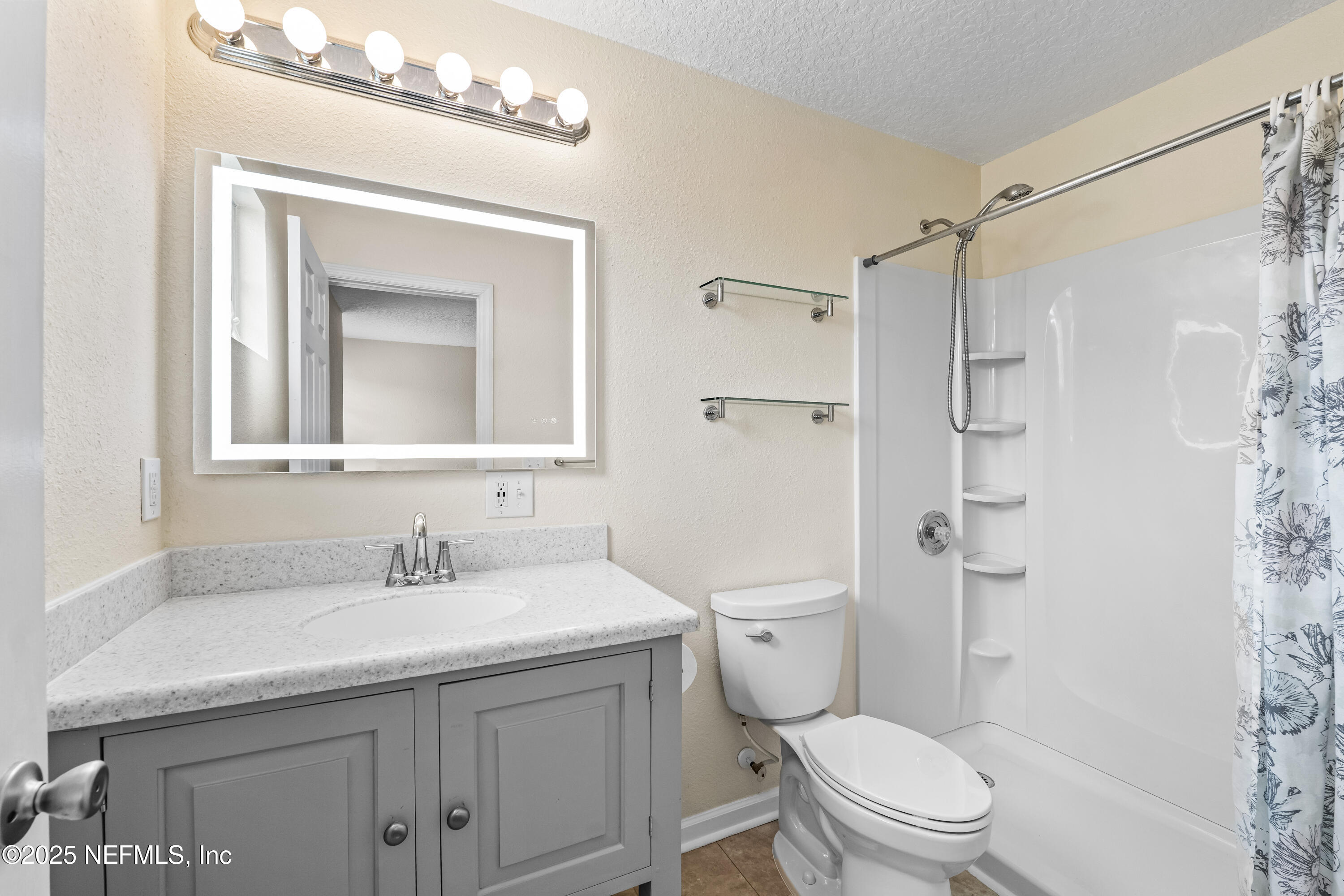 295 Islander Circle St. Augustine, FL 32080 - Photo 28 of 34 a bathroom with a toilet sink vanity and shower