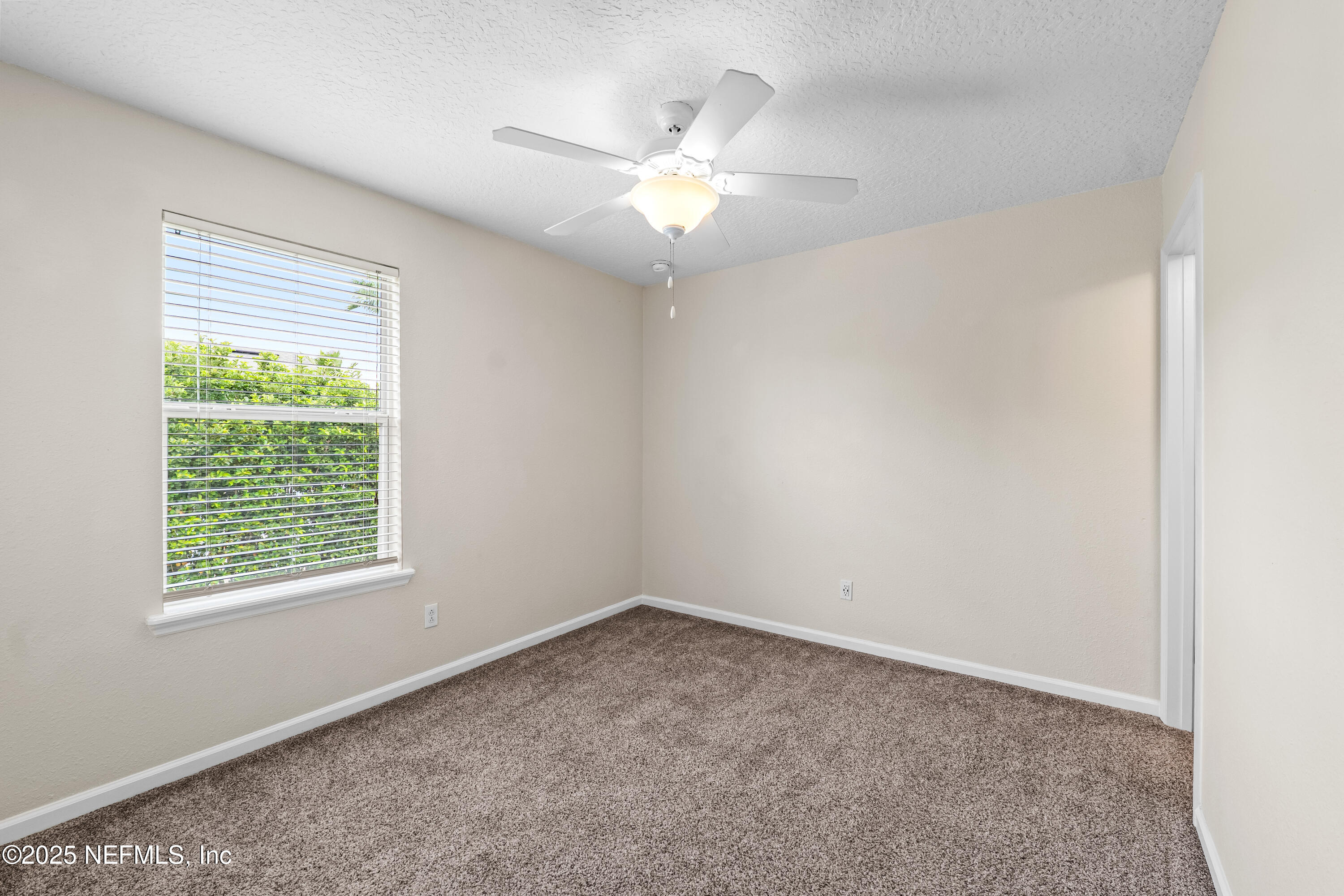 295 Islander Circle St. Augustine, FL 32080 - Photo 29 of 34 an empty room with a window and a fan