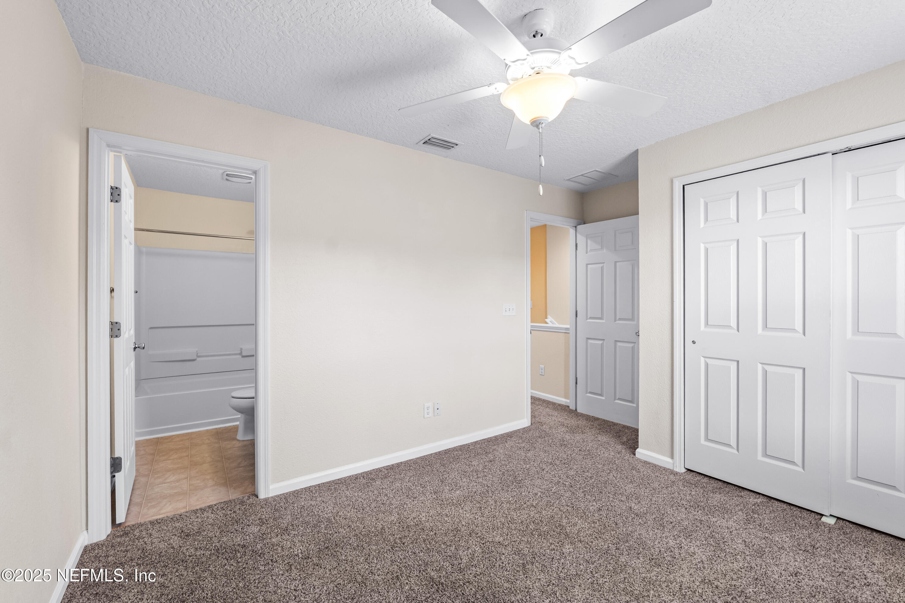 295 Islander Circle St. Augustine, FL 32080 - Photo 30 of 34 an empty room with closet and a ceiling fan