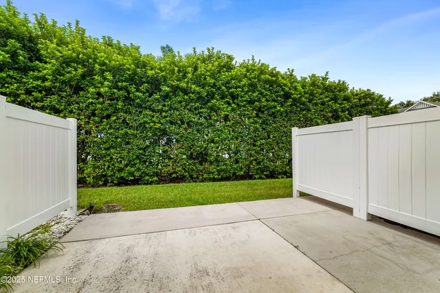 a view of backyard of house and garage