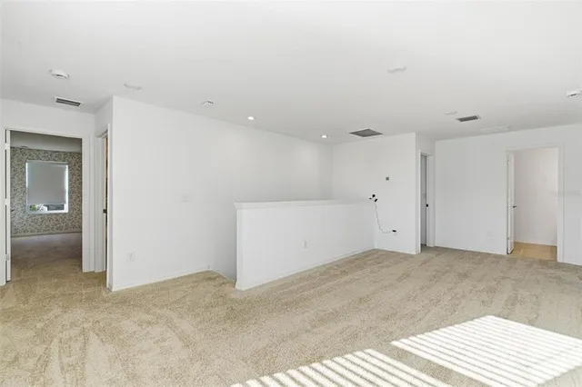 a spacious bedroom with a bed and a window