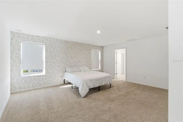 a en suite bathroom with a double vanity sink and a mirror