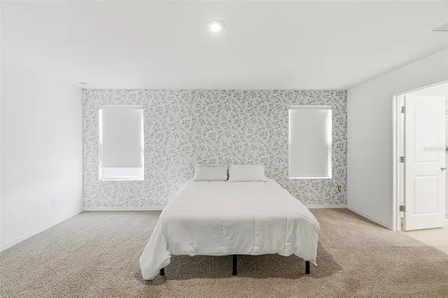 a bathroom with a double vanity sink toilet and a mirror