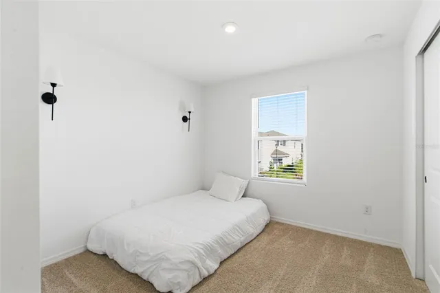 a white bath tub sitting next to a white toilet and vanity