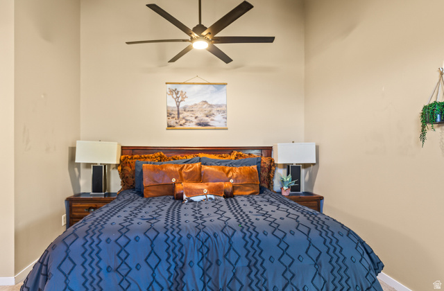 460 Omni Point Road Central Valley, UT 84754 - Photo 62 of 101 Bedroom featuring a dark wood headboard, a ceiling fan with integrated lighting, and neutral wall tones