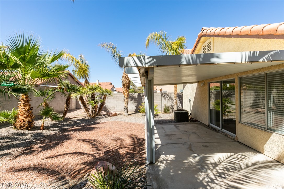 307 Cavalla Street Henderson, NV 89074 - Photo 40 of 44 A spacious backyard retreat features an expansive patio with a full-length overhead cover, ideal for alfresco dining.