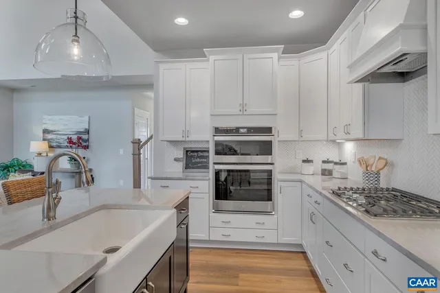 a kitchen with granite countertop a sink stove and refrigerator