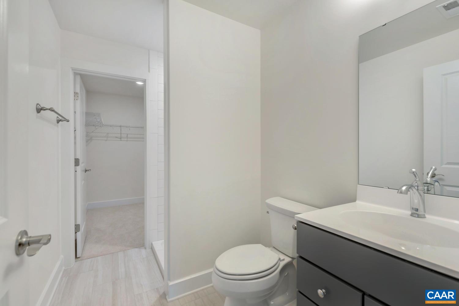 29 Portelet Road Crozet, VA 22932 - Photo 19 of 28 a bathroom with a granite countertop sink toilet and shower