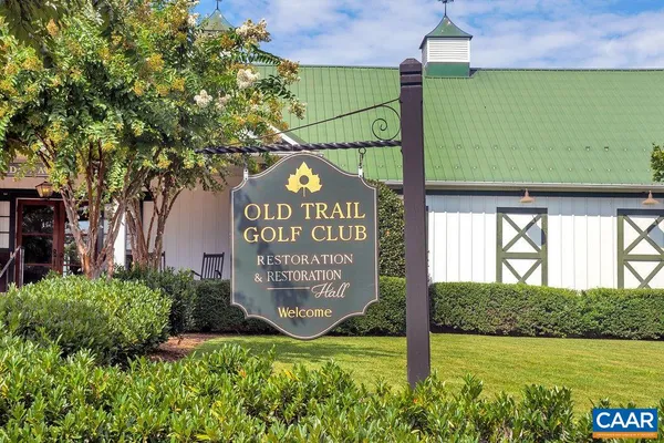 a view of a big yard with an empty house and wooden deck
