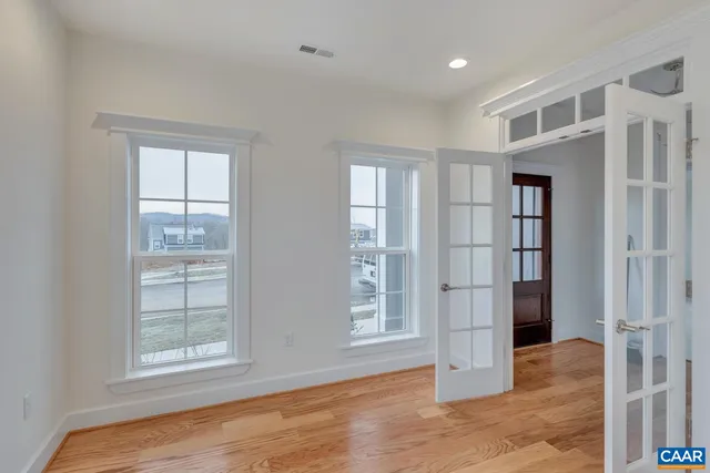 an empty room with windows and closet