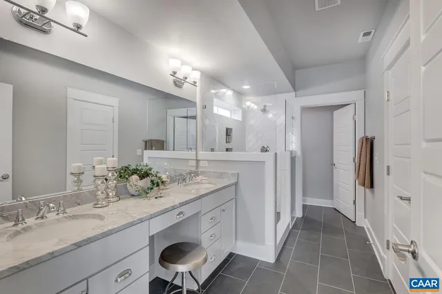 a bathroom with a double vanity sink and a mirror