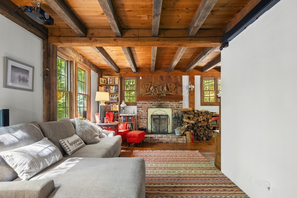 180 Holtshire Road Orange, MA 01364 - Photo 5 of 22 a living room with furniture a fireplace and a floor to ceiling window