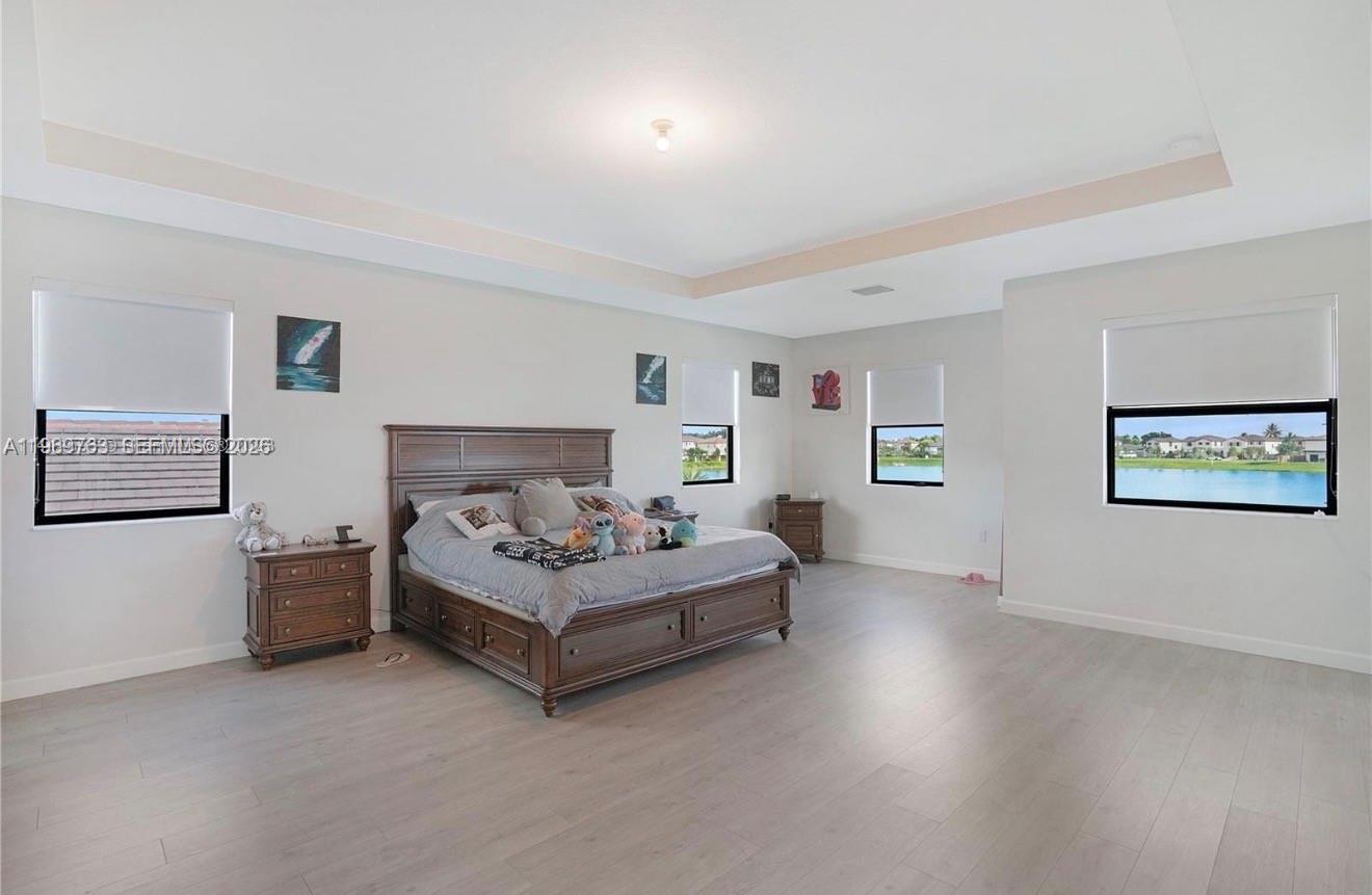 10321 Southwest 232nd Street Cutler Bay, FL 33190 - Photo 15 of 49 a spacious bedroom with a bed and a couch
