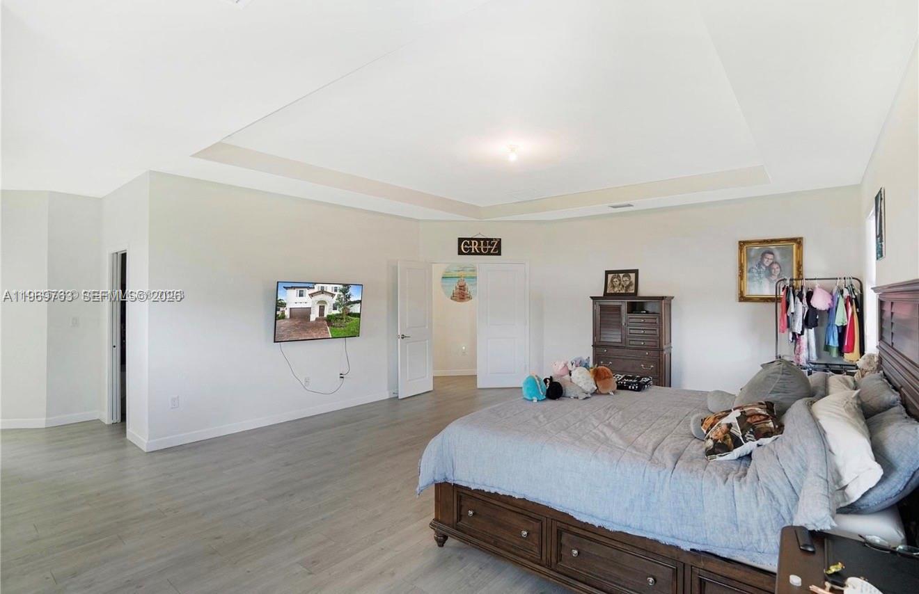 10321 Southwest 232nd Street Cutler Bay, FL 33190 - Photo 17 of 49 a bed room with a bed and a view of kitchen
