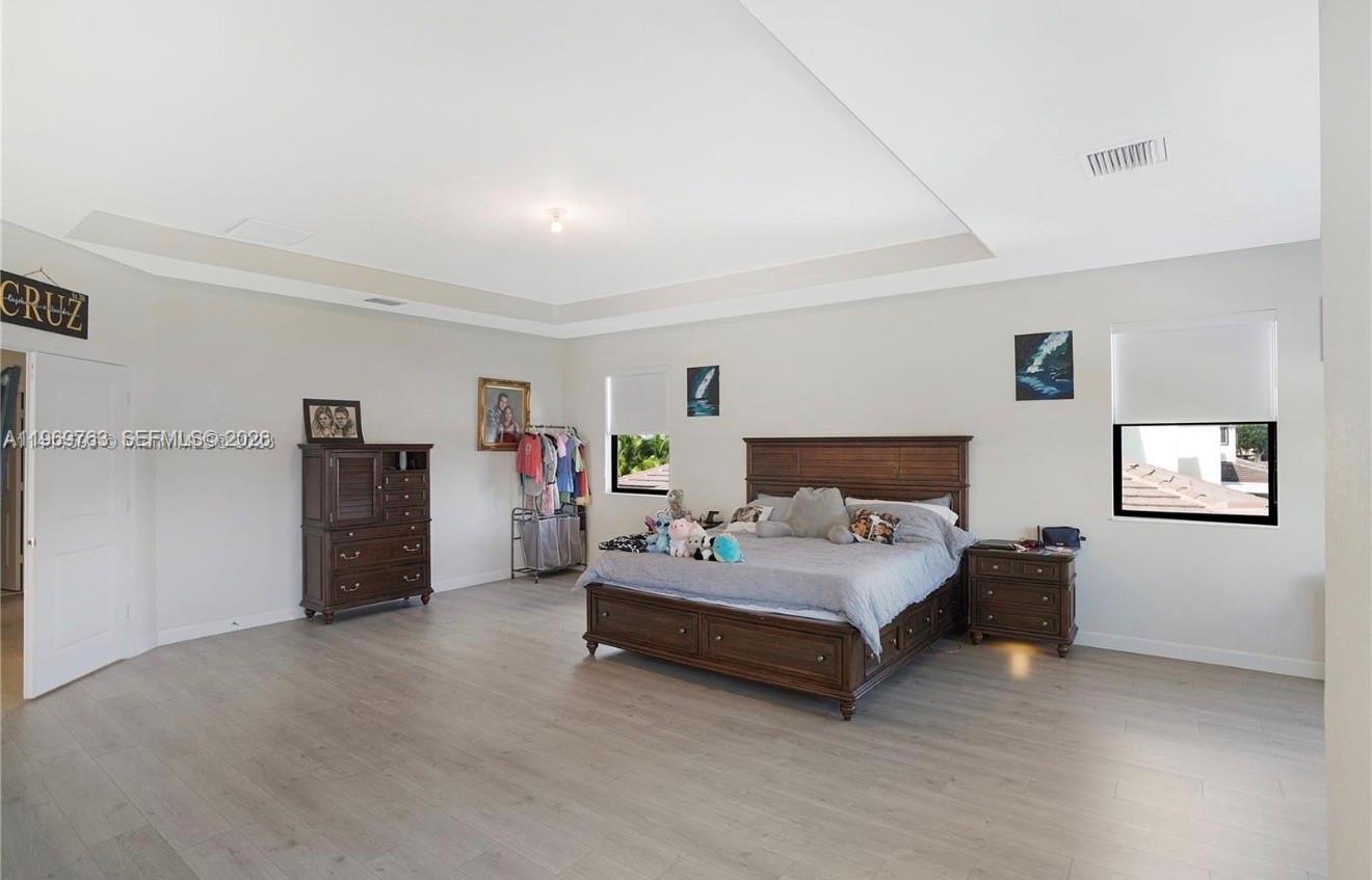 10321 Southwest 232nd Street Cutler Bay, FL 33190 - Photo 18 of 49 a spacious bedroom with a bed and a walk in closet