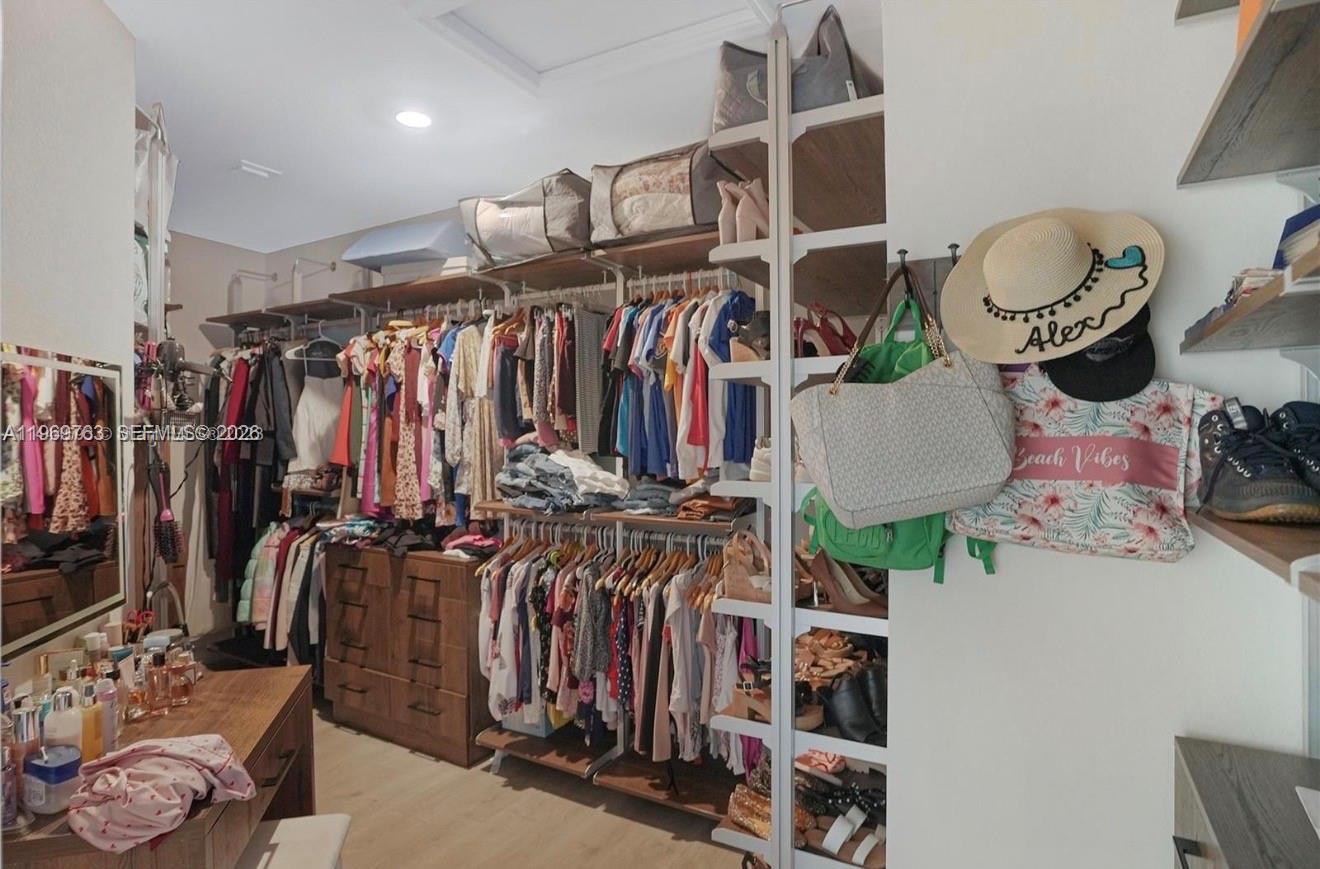 10321 Southwest 232nd Street Cutler Bay, FL 33190 - Photo 19 of 49 a view of walk in closet with clothes and shoes