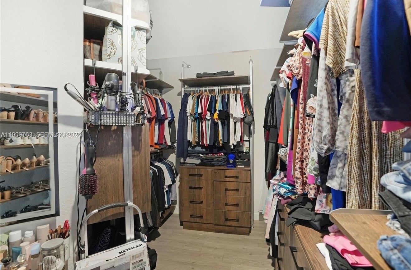 10321 Southwest 232nd Street Cutler Bay, FL 33190 - Photo 20 of 49 a view of walk in closet with clothes