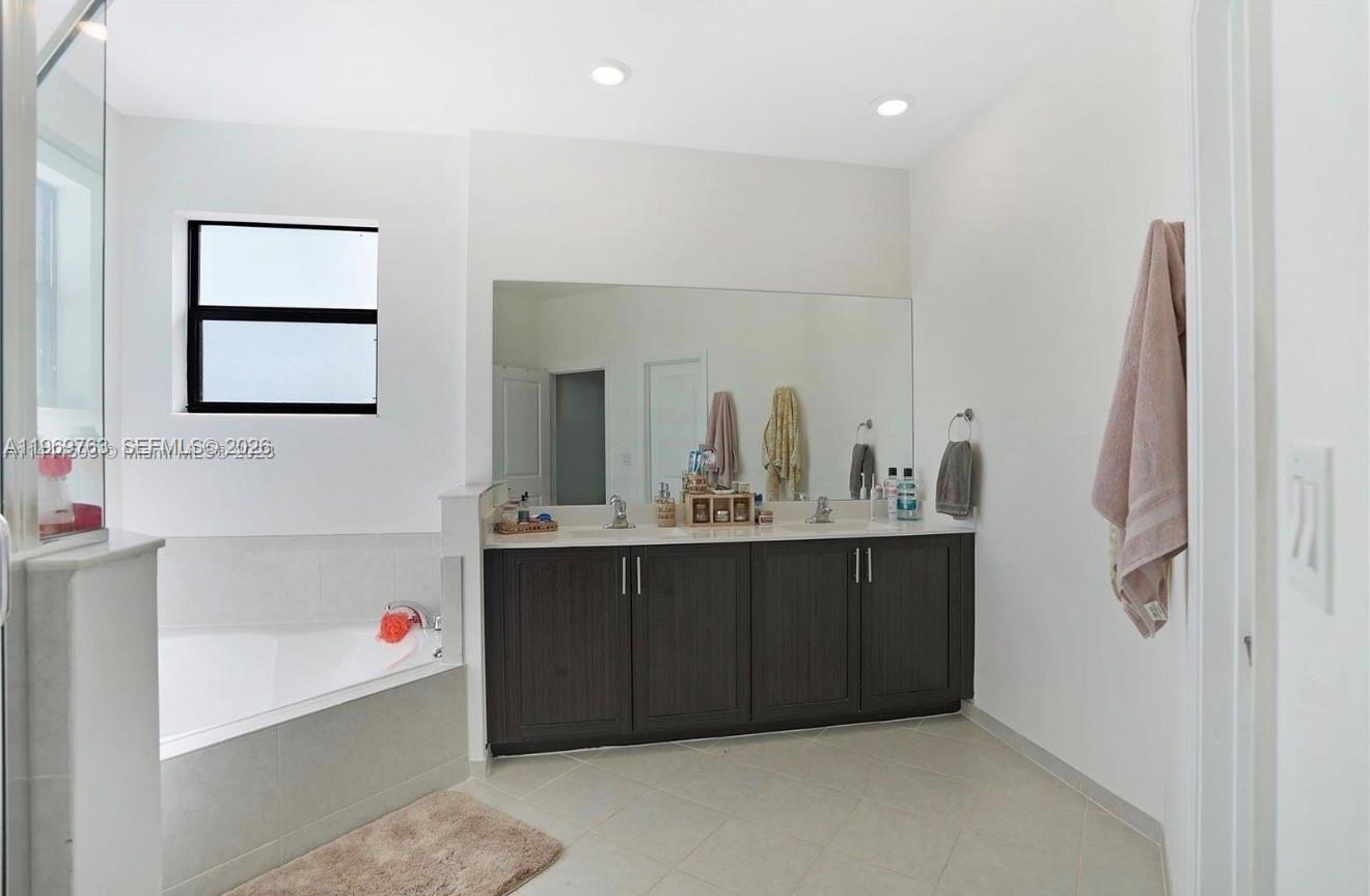 10321 Southwest 232nd Street Cutler Bay, FL 33190 - Photo 21 of 49 a bathroom with a sink and a mirror