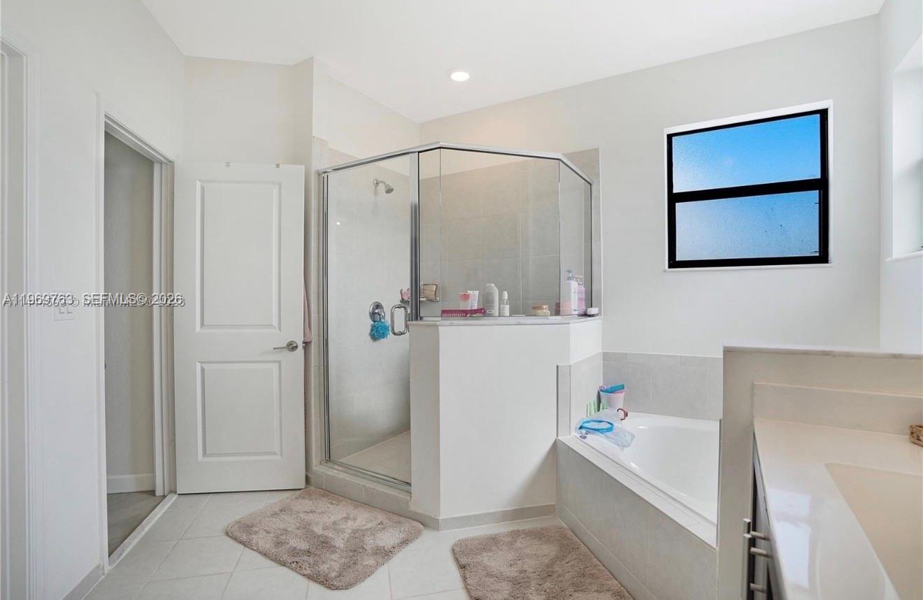10321 Southwest 232nd Street Cutler Bay, FL 33190 - Photo 22 of 49 a bathroom with a bathtub sink and toilet
