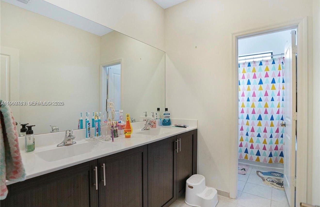 10321 Southwest 232nd Street Cutler Bay, FL 33190 - Photo 23 of 49 a bathroom with a sink toilet and shower