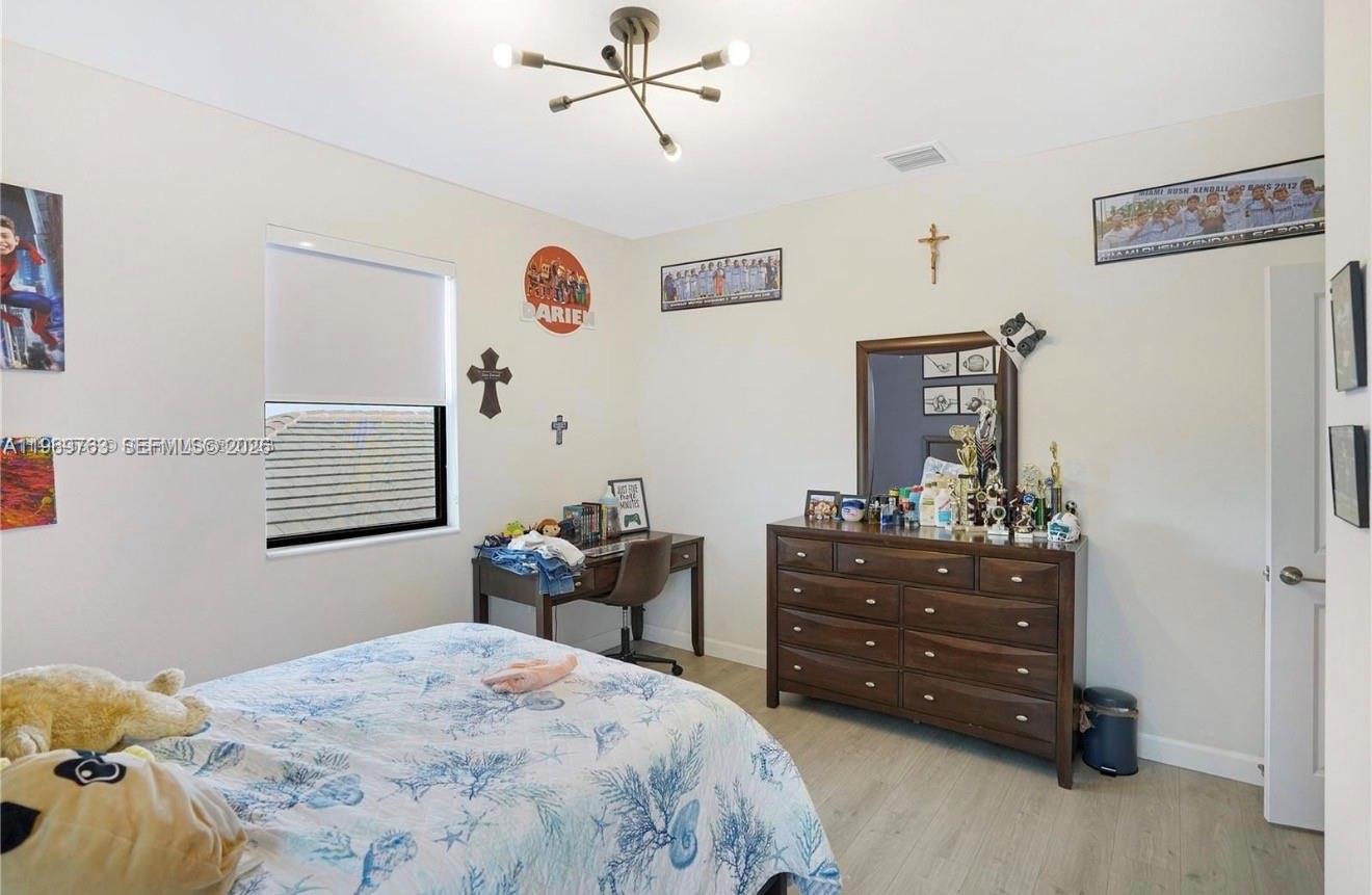 10321 Southwest 232nd Street Cutler Bay, FL 33190 - Photo 26 of 49 a bedroom with a bed and a dresser