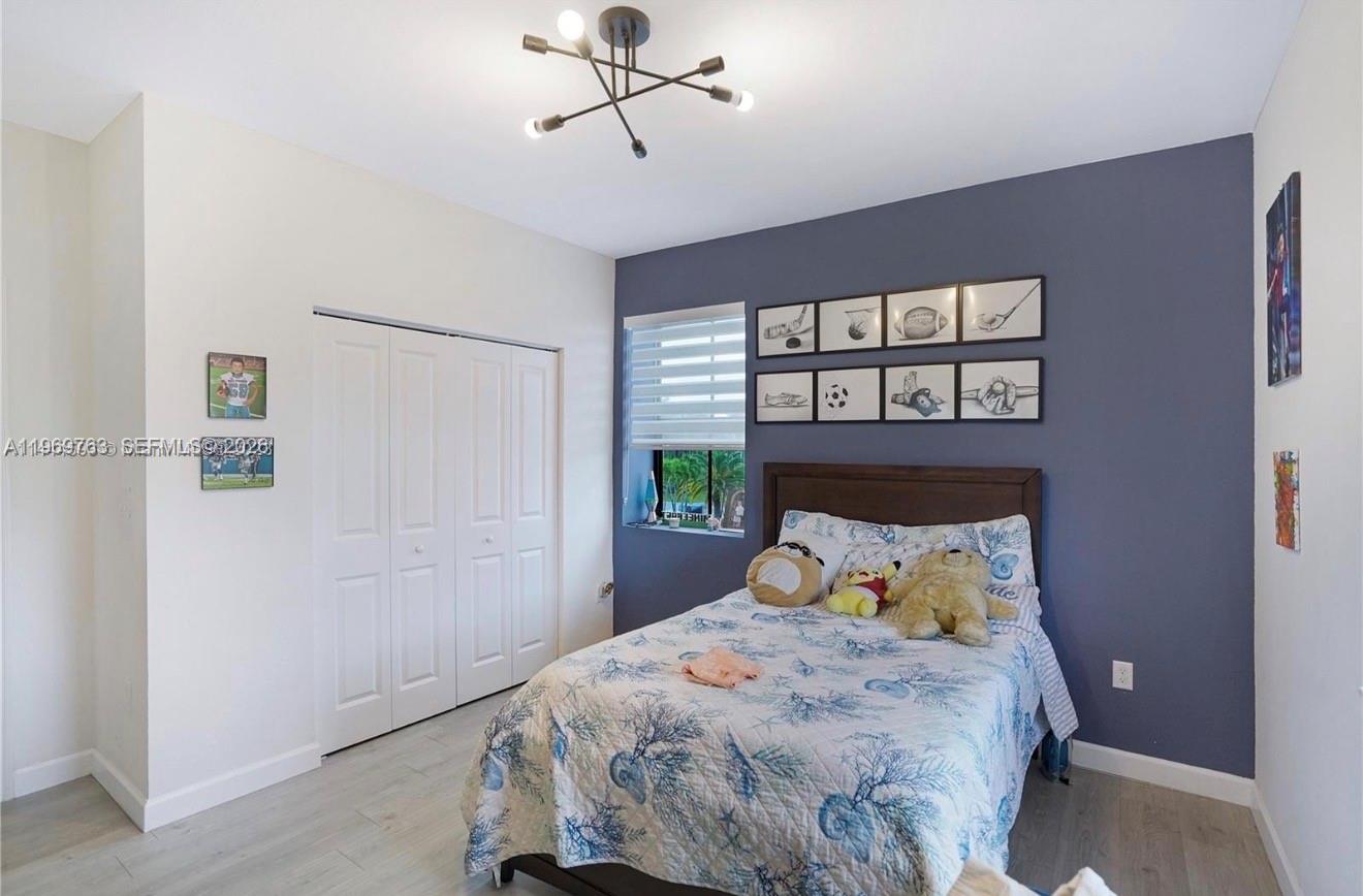10321 Southwest 232nd Street Cutler Bay, FL 33190 - Photo 28 of 49 a bedroom with a bed and a window