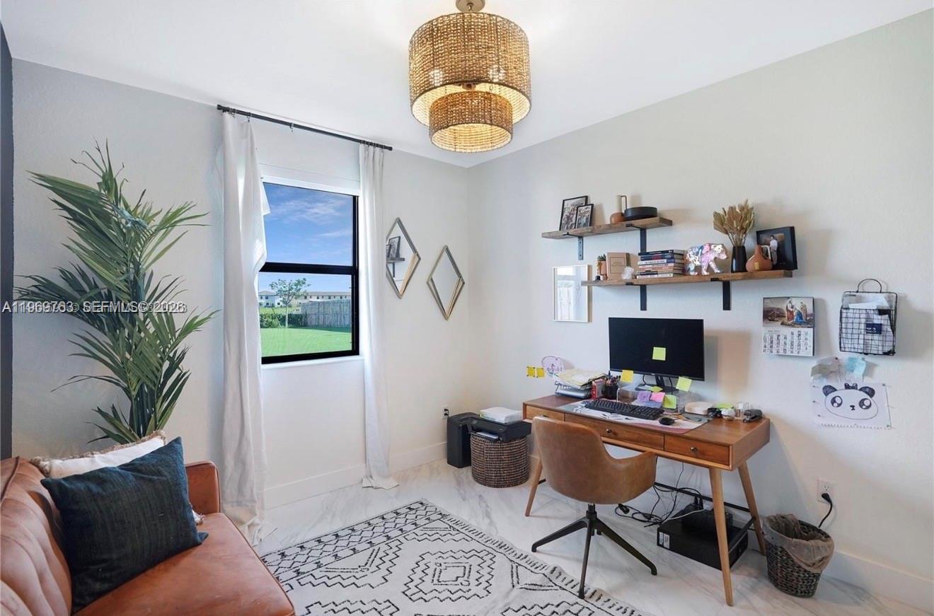 10321 Southwest 232nd Street Cutler Bay, FL 33190 - Photo 32 of 49 a living room with furniture and a potted plant
