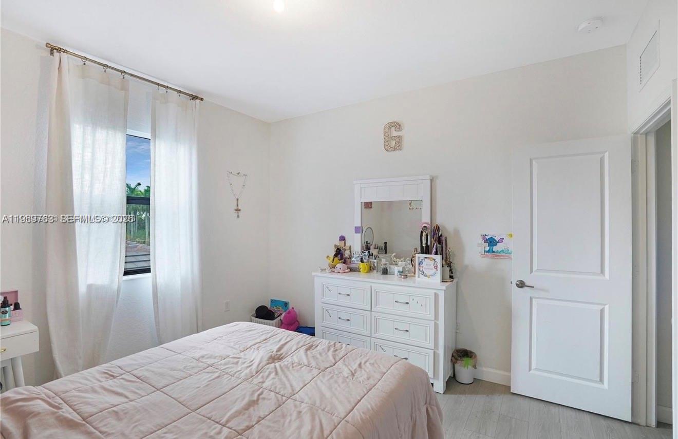 10321 Southwest 232nd Street Cutler Bay, FL 33190 - Photo 36 of 49 a bedroom with a bed and a closet