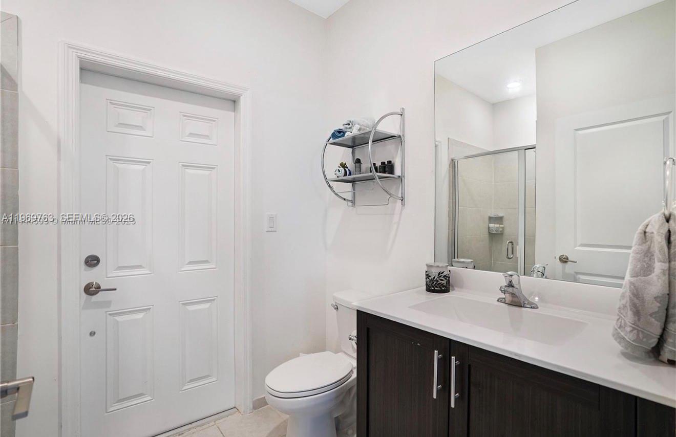 10321 Southwest 232nd Street Cutler Bay, FL 33190 - Photo 39 of 49 a bathroom with a sink a toilet and shower