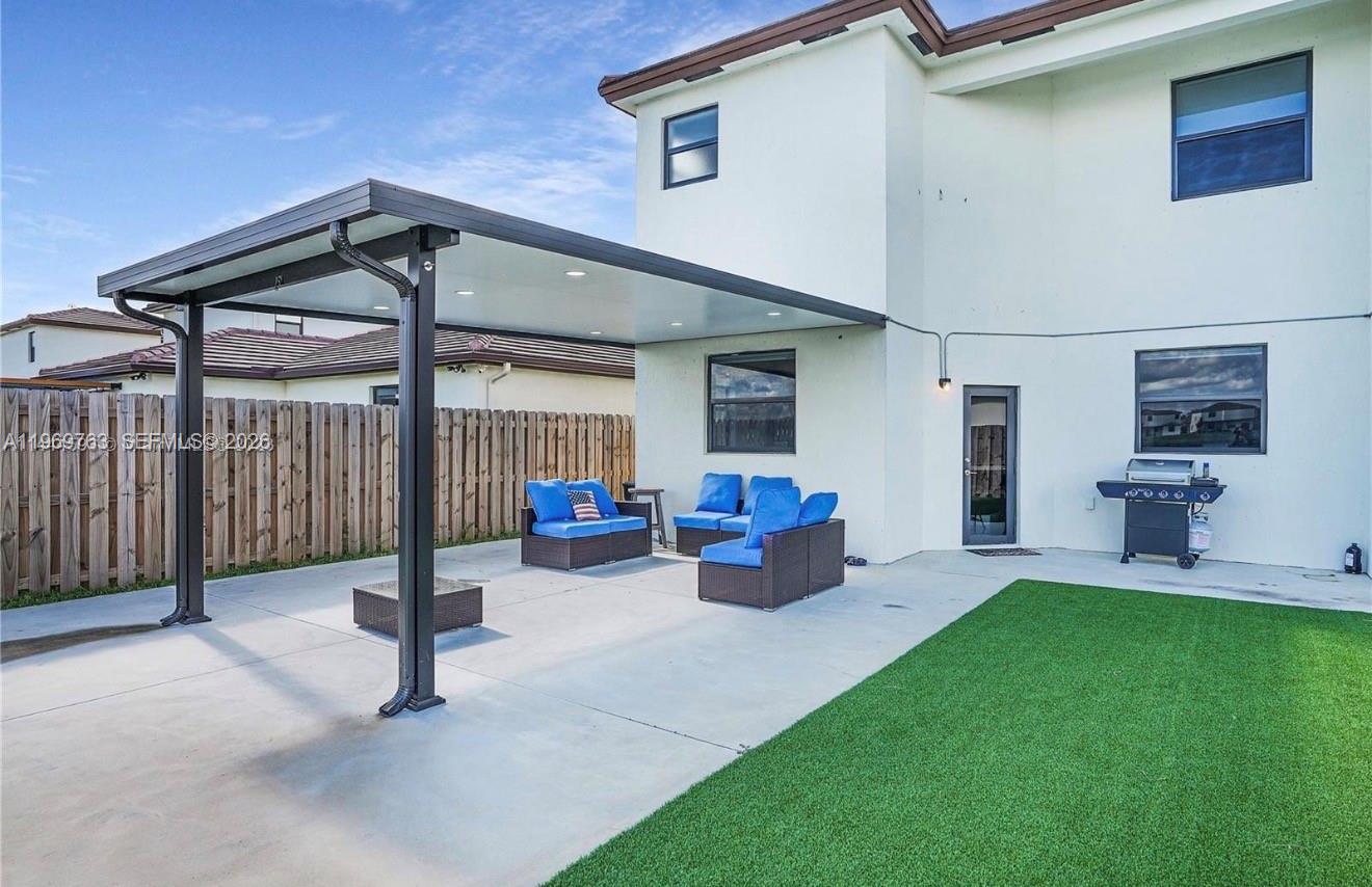 10321 Southwest 232nd Street Cutler Bay, FL 33190 - Photo 41 of 49 a view of a house with backyard and porch