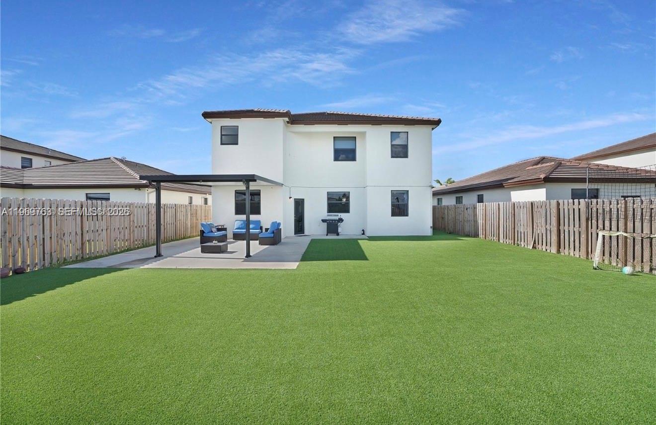 10321 Southwest 232nd Street Cutler Bay, FL 33190 - Photo 45 of 49 a view of a house with backyard and porch