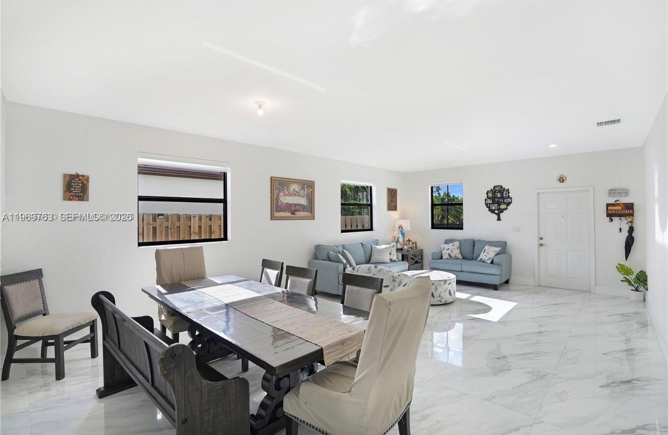 10321 Southwest 232nd Street Cutler Bay, FL 33190 - Photo 5 of 49 a view of a livingroom with furniture and a table in it