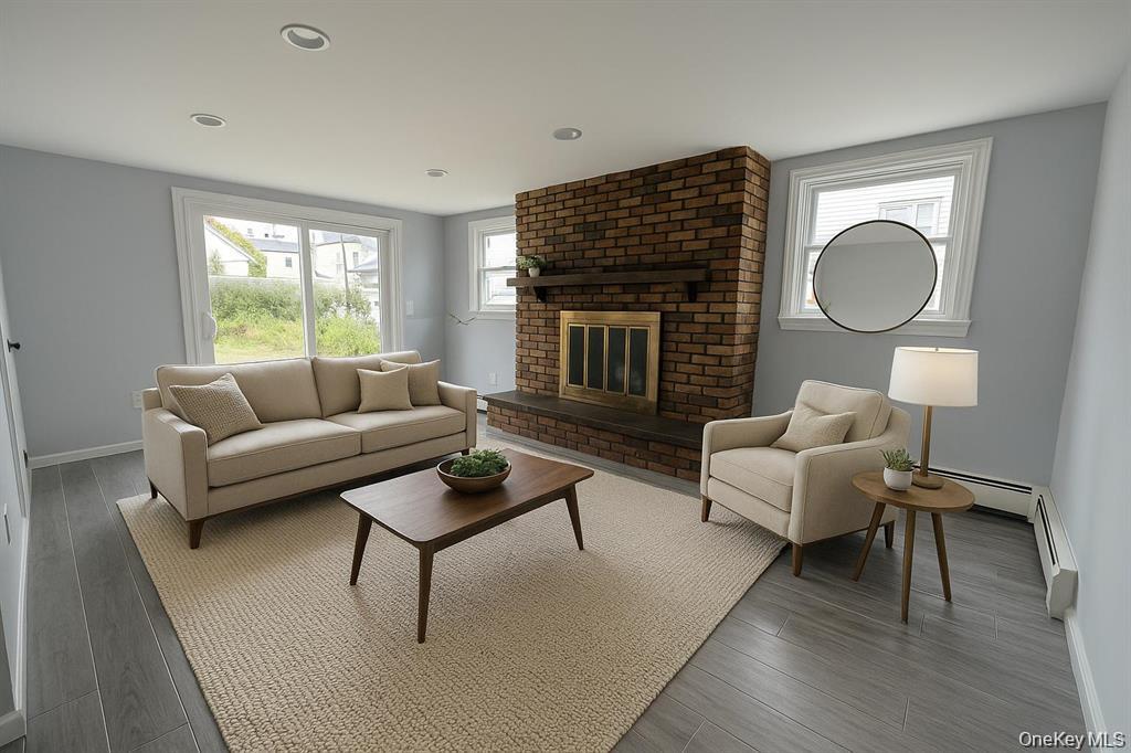 324 Buckingham Road Cedarhurst, NY 11516 - Photo 3 of 12 a living room with furniture wooden floor and a fireplace
