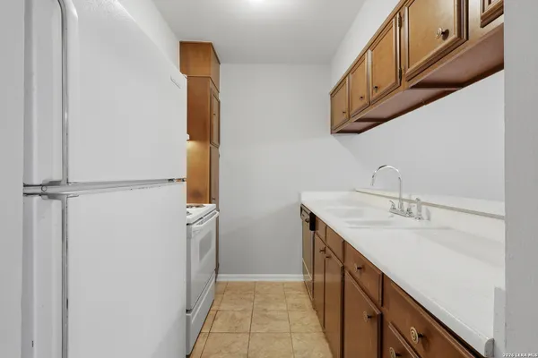 a kitchen with a sink cabinets and utility