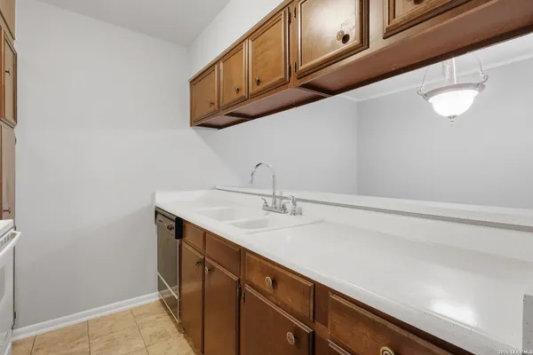 a kitchen with stainless steel appliances a refrigerator sink and cabinets
