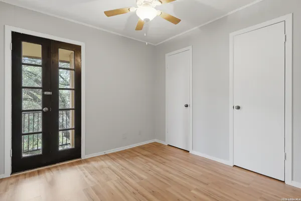 a view of a hallway with wooden floor