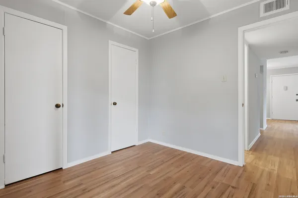 a view of balcony with floor to ceiling window and wooden fence