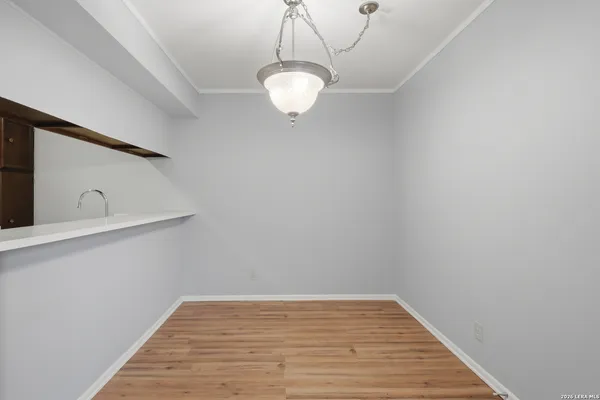 a view of a room with wooden floor and fan