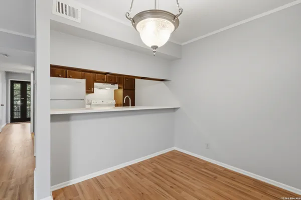a view of kitchen with wooden floor and fan