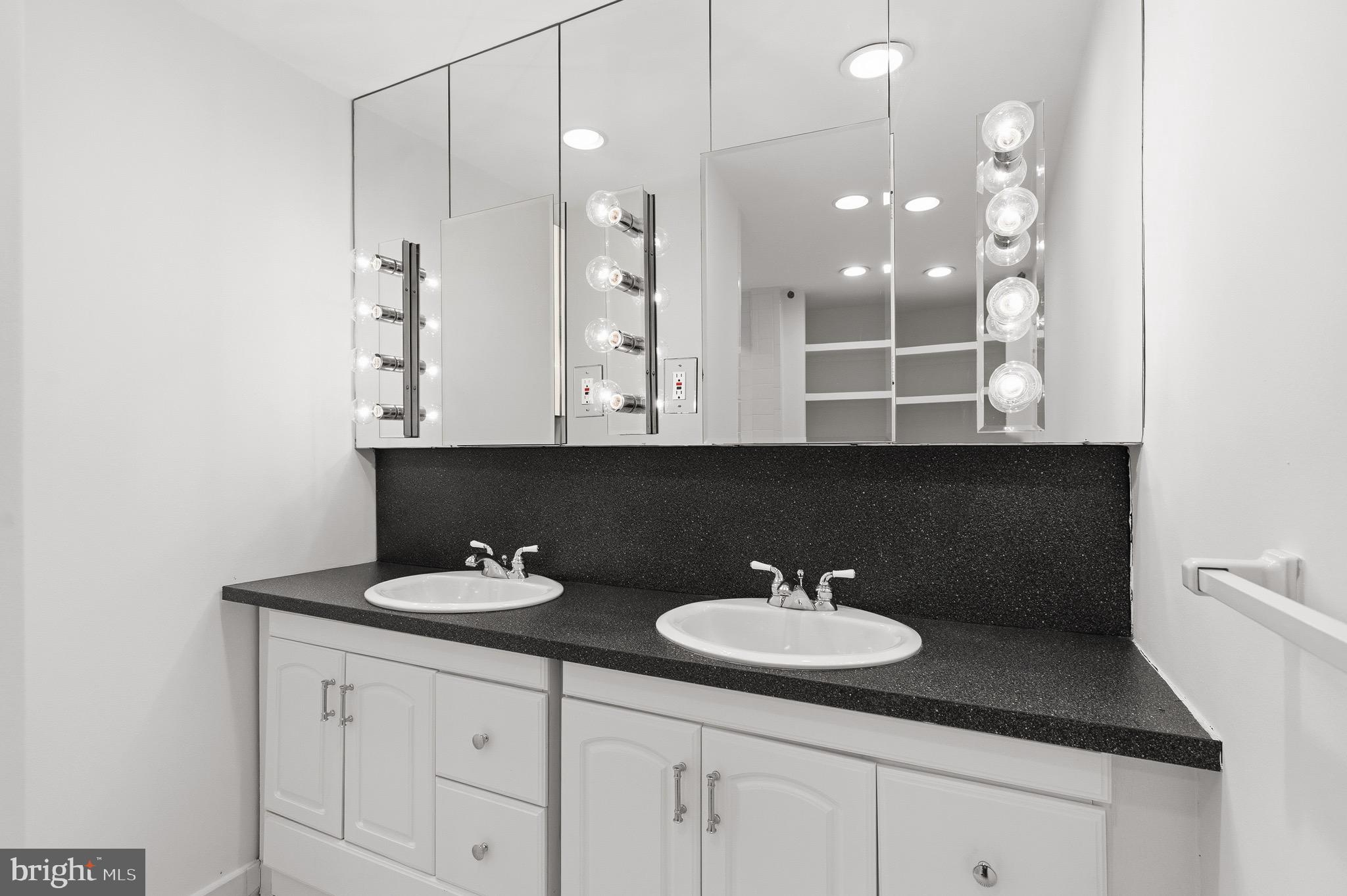 4000 Cathedral Avenue Northwest, Unit 334B/335B Washington, DC 20016 - Photo 18 of 32 a bathroom with a sink and a mirror