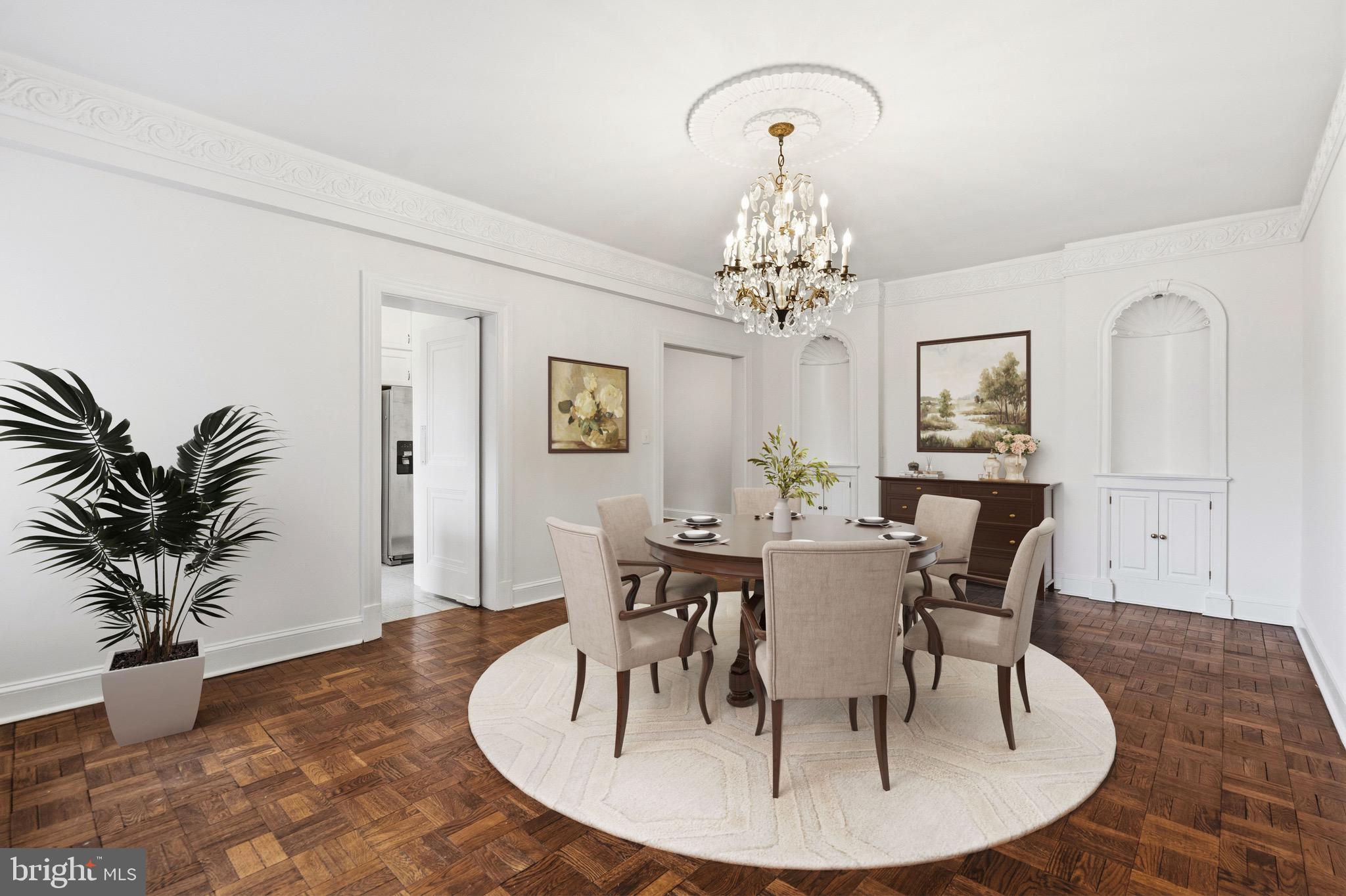 4000 Cathedral Avenue Northwest, Unit 334B/335B Washington, DC 20016 - Photo 4 of 32 a dining room with wooden floor a chandelier a wooden table and chairs