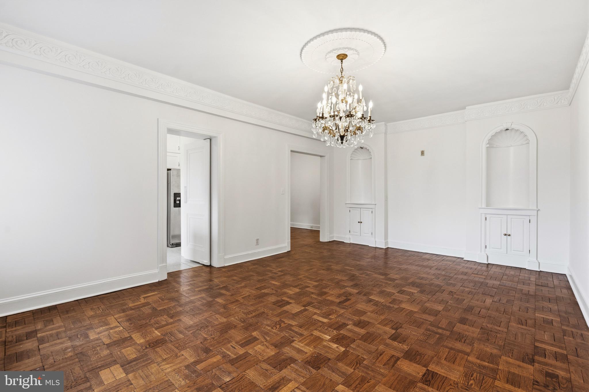 4000 Cathedral Avenue Northwest, Unit 334B/335B Washington, DC 20016 - Photo 5 of 32 a view of a chandelier in an empty room