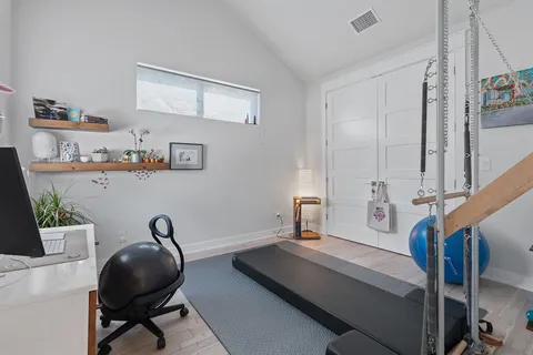 a view of a workspace with furniture and a window