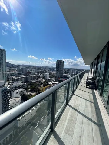 a view of balcony with wooden floor