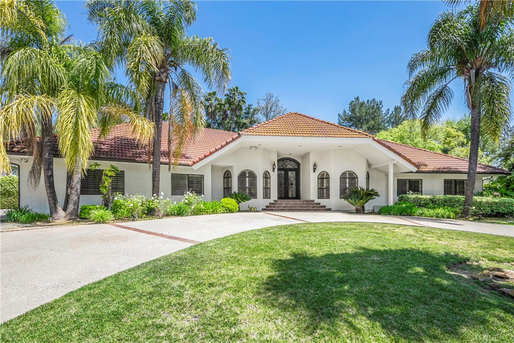 1307 Highland Pass Road Chino Hills, CA 91709 - Photo 1 of 1 a front view of a house with a yard and palm trees